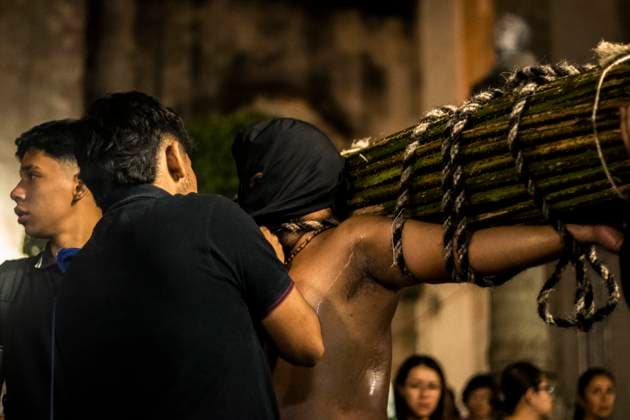 México: Good Friday in Taxco Guerrero Penitent citizen on his way to the church Penitents of Taxco carried out their traditional procession of the Three Fallen among cobblestone streets accompanied by sounds and prayers. During the procession you can see how the penitents flagellate themselves or carry sticks of thorns to demonstrate their faith towards God. Tourists and pilgrims arrived in the city to witness this traditional ritual. Taxco Guerrero Mexico Taxco Guerrero Copyright: LuisxSalgado