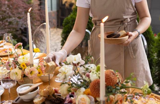 Wedding table for guests, decorated with candles, are served with cutlery and crockery and covered with yellow tablecloth Wedding. Banquet. Chairs and a table for guests, decorated with candles, are served with cutlery and crockery and covered with yellow tablecloth. Waiter setting table stands on a green lawn in the backyard banquet area ,model released, Symbolfoto Copyright: xZoonar.com DashaxPetrenkox 19754723 ,model released, Symbolfoto ,property released