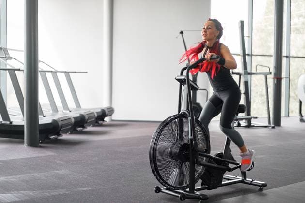RECORD DATE NOT STATED Woman exercise bike gym cycling training fitness. Fitness female using air bike cardio workout. Athlete girl sportswear biking indoor gym exercising his legs. Cross functional training., model released, , 32030282.jpg, woman, exercise, bike, gym, air, cycling, training, cardio, fitness, workout, club, athlete, fit, determined, effort, endurance, exercising, one person, athletic, indoors, hair extensions, strength, working, girl, machine, mid adult, powerful, race, smiling, stationary, red, wellbeing, wellness, bicycle, female, cycle, happy, person, sport, spinning, health, healthy lifestyle, sportive, body, cross, functional, health club, caucasian, biking, sports equipment