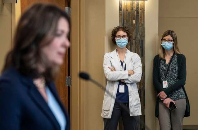 April 11, 2023, SHERWOOD PARK, AB, CANADA: A healthcare worker gives the middle finger as Alberta Premier Danielle Smith announces a public health guarantee in Sherwood Park, Alta., Tuesday, April 11, 2023. SHERWOOD PARK CANADA  - ZUMAc35_ 20230411_zaf_c35_019 Copyright: xJasonxFransonx