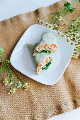 RECORD DATE NOT STATED a vertical High angle closeup of a salmon wrap sliced in half *** einer hoch hohe Winkel closeupe des einer Lachs wickeln aufgeschnittenen ÊIn halb 10474768