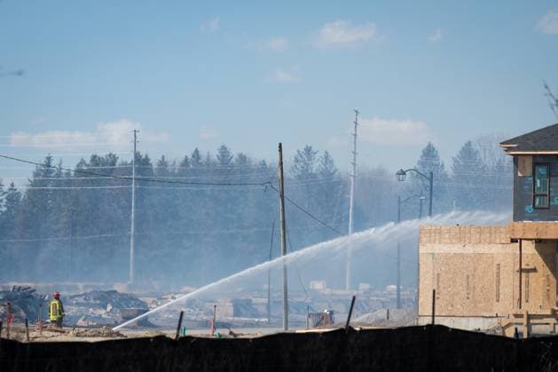 April 12, 2023, Vaughan, ONT, CANADA: A Firefighter walks through the damage as they continue to battle a large fire in a new housing development area near Pine Heights and Teston Road, in Vaughan, Ont., Wednesday, April 12, 2023. Vaughan CANADA  - ZUMAc35_ 20230412_zaf_c35_034 Copyright: xTijanaxMartinx