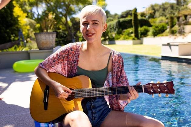 Portrait of happy caucasian woman having pool party, playing guitar and smiling in garden Portrait of happy caucasian woman having pool party, playing guitar and smiling in garden. Lifestyle, friendship, party and summer., model released, , property released, Cape Town, South Africa, 2023-01-25T22:00:00.000Z, 4017914.jpg, people,portrait,happy,caucasian woman,pool party,playing guitar,smiling,garden,lifestyle,friendship,summer,young,person,beautiful,adult,cheerful,happiness,attractive,fun,smile,nature,cute,beauty,pretty,outdoor,leisure,face,together,spring,green,caucasian,woman,pool,party,playing,guitar Non-binary,White