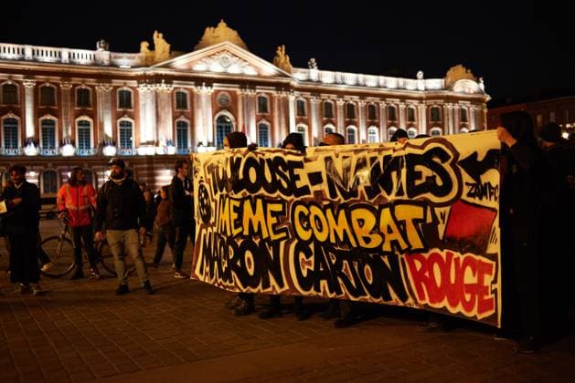 Pot Concert During Macron s Speech On Tvs And Radios Protesters hold a banner reading Toulouse-Nantes, same fight, Macron red card in front of the Capitole. A few thousands people gathered in front of the Capitole in Toulouse for a pot concert at the same French President Macron spoke on TVs and radios. They are angered by the decision to validate the pension bill by the consitutional council and its promulgation by Macron soon after. The pension bill will delay retirement by two years to 64 and was pushed through parliament by the government without a vote.Polls show 64% french people say they want the stirkes to intensify and that 93% of workers oppose the pension reform. The retirement age would be raised to 64 years (for 43 years of c  Copyright: xAlainxPittonx originalFilename: pitton-notitle230417_npYZa.jpg