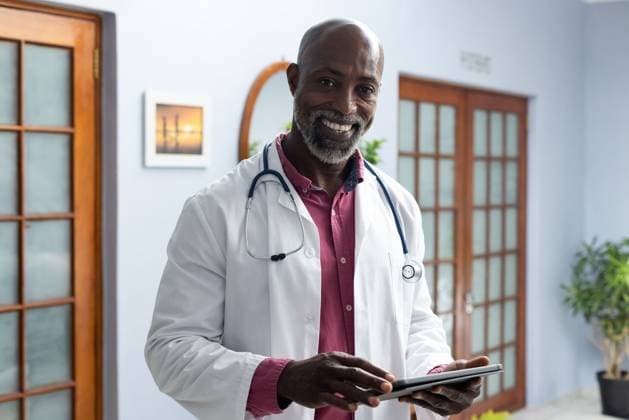 Portrait of happy african american male doctor wearing stethoscope using tablet at doctor s office Portrait of happy african american male doctor wearing stethoscope using tablet at doctor s office. Hospital, medicine, healthcare and communication., model released, , property released, Cape Town, South Africa, 2023-02-10T22:00:00.000Z, 4020837.jpg, people,portrait,happy,african american,male doctor,doctor office,wearing,stethoscope,using tablet,office,hospital,medicine,healthcare,communication,medical,doctor,clinic,care,health,patient,treatment,young,illness,professional,person,pills prescription,nurse,disease,adult,physician,smile,specialist,workplace,african,american,male,using,tablet Mature Adult,Man,Male,Black
