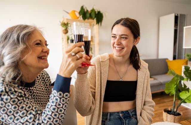 Happy mother and daughter toasting wineglasses at home model released, Symbolfoto property released, JCCMF10185