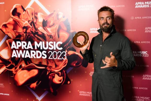2023 APRA MUSIC AWARDS, Xavier Rudd holds his APRA Award for Most Performed Blues and Roots Work at the 2023 APRA Music Awards at the International Convention Centre, in Sydney, Thursday, April 27, 2023. ( NO ARCHIVING, EDITORIAL USE ONLY, NO USE IN BOOKS WITHOUT CONSENT SYDNEY NSW AUSTRALIA  Copyright: xJAMESxGOURLEYx 20230427001791484006