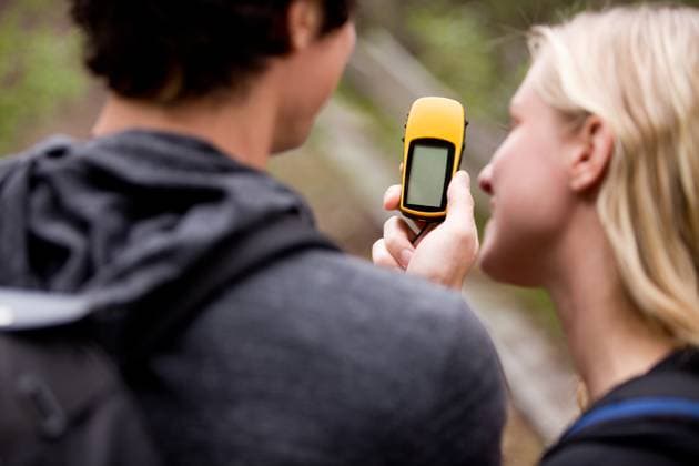 A couple outdoors in the forest using a GPS. Sharp focus on the GPS device. Copyright: xTylerxOlsonx xDesignxPicsx , 30527248 Copyright: TylerxOlsonx xDesignxPics 30527248