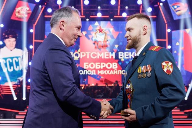 RUSSIA, MOSCOW - APRIL 29, 2023: Russian Olympic Committee chairman Stanislav Pozndyakov (L) presents an award to a CSKA athlete at a concert marking the centenary of the CSKA sports club at the Central Academic Theatre of the Russian Army. Vadim Savitsky Russian Defence Ministry Press Office TASS  58743384