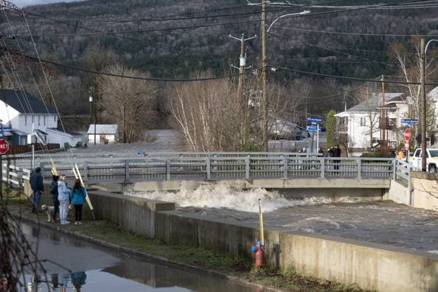 May 1, 2023, BAIE SAINT-PAUL, PQ, CANADA: People look on as a city bridge flooded by a river on Monday, May 1, 2023 in Baie-Saint-Paul, Quebec. In Baie-St-Paul, Que., around 90 kilometres northeast of the provincial capital, the mayor declared a state of emergency due to heavy rains that washed away roads and isolated homes. BAIE SAINT-PAUL CANADA - ZUMAc35_ 20230501_zaf_c35_095 Copyright: xJacquesxBoissinotx