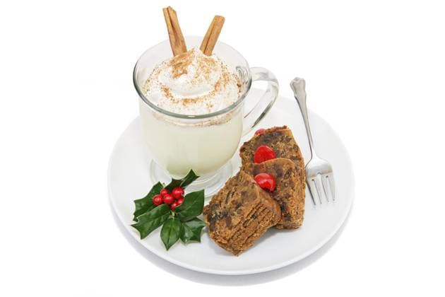 Delicious Christmas fruitcake served with a foamy mug of eggnog. Isolated on white with clipping path. Copyright: xLisaxF.xYoungx xDesignxPicsx , 30771222 Copyright: KamranxAkhlaqx xDesignxPics 30771222