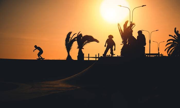 A group of teenage on skateboard at summer, silhouette unrecognizable. Lima, Callao Region, Peru CR_DOQO230503CE-1179359-01