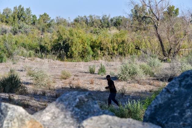 YUMA, AZ - MAY 11: Migrants seen set to cross the border at Cocopah Indian Reservation before Title 42 is set to end at 11:59pm allowing all migrants to apply for asylum after the three-year COVID-era health ban. Yuma, Arizona on May 11, 2023. Copyright: xDeeCeexCarterx