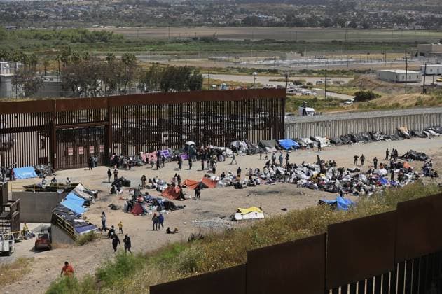 Migrants have been stuck between the primary and secondary fencing at the Tijuana-San Diego border for over a week, as many of the migrants are waiting and hoping to be allowed to immigrate to the U.S. more easily after the Title-42 deportation order expires on May 11, as seen from Tijuana, Mexico on Thursday, May 11, 2023.  TIJ2023051102 CarlosxMoreno
