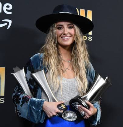 Lainey Wilson shows off her four awards, Female Artist of the Year, Album of the Year for Bell Bottom Country plus Visual Media of the Year and Music Event of the Year at the Academy of Country Music Awards at The Star in Frisco, TX on Thursday, May 11, 2023.  FRS20230511512 IANxHALPERIN