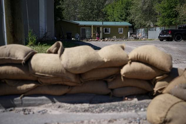 May 14, 2023, CACHE CREEK, BC, CANADA: Sandbags are seen stacked on the curb outside a home near the Bonaparte River in Cache Creek, B.C., on Sunday, May 14, 2023. Environment Canada says unseasonably hot temperatures in British Columbia will persist over the coming days, with special weather statements warning of high river streamflows due to melting snow in hard-hit communities in the province s interior. CACHE CREEK CANADA  - ZUMAc35_ 20230514_zaf_c35_115 Copyright: xDarrylxDyckx