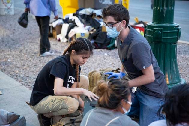 May 13, 2023, El Paso, Texas, USA: BRYCE KINNAIORD, a 24-year-old medical assistant and Army Veteran from Horizon City, Texas, treats minor injuries and illnesses of asylum-seekers from Venezuela, who crossed the border from Juarez, Mexico this week with the lifting of Title 42. Kinnaiord decided to come down to help out when he learned about the migrants living on the sidewalk outside the Sacred Heart Catholic Church. He pays for the bandages, ointments and over-the-counter medications himself. He said I believe people should come here the right way, but since they are here in our country, helping them is the right thing for us to do. The most common things he has been seeing, he said, are dehydration, covid, colds and headache. He e - ZUMAs li 20230513_new_s241_036 Copyright: xBelindaxSoncinix