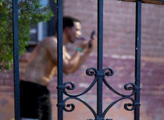 May 13, 2023, El Paso, Texas, USA: A young man from Venezuela, who recently crossed the border from Juarez, Mexico, washes himself and shaves at a spigot outside the Sacred Heart Catholic Church. More than a hundred asylum seekers from Latin America are living temporarily on the sidewalks surrounding the church, until they can arrange more stable housing with family or friends in the US. Without sufficient facilities in the church, they make do with what they can find. For Venezuelans, being cleaned and groomed is important. His asylum hearing isn t until November, on the east coast. He is hoping to stay with his cousin in Pennsylvania until he can start his own business in the US and bring his wife and four kids from Venezuela. El Paso US - ZUMAs li 20230513_new_s241_037 Copyright: xBelindaxSoncinix