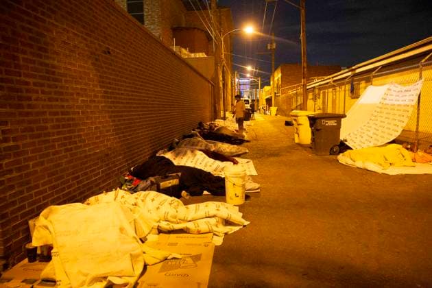 May 13, 2023, El Paso, Texas, USA: An alley behind the Sacred Heart Catholic Church has become the home of dozens of migrants, many fleeing threats and oppression by the Venezuelan government. The majority of these men and women had homes and jobs in their country and had never slept on the street or been homeless before arriving in the US. Most were processed at the border then released in El Paso, with no money and nowhere to go. Several asylum seekers reported that the Border Patrol had taken away their belts and shoe laces. while they were being held, and had thrown away many of their personal belongings, including medicine. They sleep on the pavement or, if lucky, on cardboard. They have only thin blankets dropped off by the Red Cross - ZUMAs li 20230513_new_s241_043 Copyright: xBelindaxSoncinix