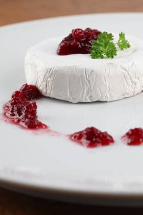 Camembert with cranberry jam and parsley on white plate. Shallow dof Copyright: xIngridxHeczkox xDesignxPicsx , 31116029 Copyright: ElenaxNovikovax xDesignxPics 31116029