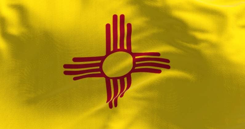 Close-up of the New Mexico state flag waving Close-up of the New Mexico state flag waving. US state flag. Yellow field with a red Zia sun symbol in the center. 3d illustration render. Close-up. Textured background Copyright: xZoonar.com ValerioxRosatix 19962990