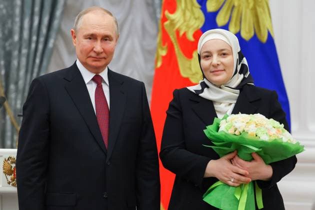 RUSSIA, MOSCOW - MAY 23, 2023: Russia s President Vladimir Putin awards the Mother Heroine title to large family mother Medni Kadyrova during a ceremony to present state decorations at the Moscow Kremlin. Vyacheslav Prokofyev TASS  59317541