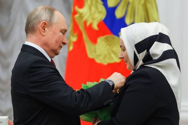 RUSSIA, MOSCOW - MAY 23, 2023: Russia s President Vladimir Putin awards the Mother Heroine title to large family mother Medni Kadyrova during a ceremony to present state decorations at the Moscow Kremlin. Vyacheslav Prokofyev TASS  59317702
