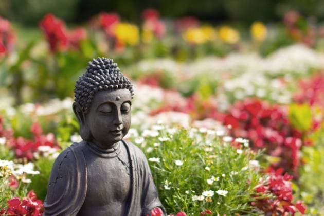 Buddhafigur im bunt bluehenden Garten Buddha statue between flowers BLWS687330 *** Buddha figure at bunt blooming Garden Buddha Statue between Flowers BLWS687330 Copyright: xblickwinkel M.xWuchenauerx