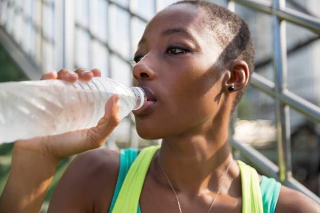 Contemplative woman drinking water from bottle model released, Symbolfoto, IKF00450