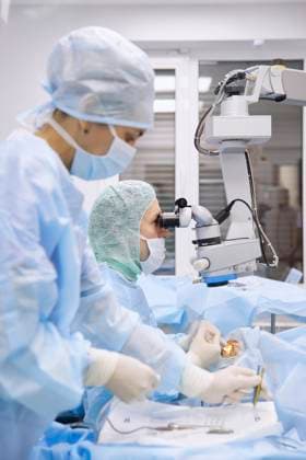 Nurse with doctor performing eye surgery in operating room model released, Symbolfoto property released, SANF00092