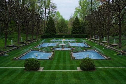 A fountain in Longwood Gardens among the trees *** einer Fontäne ÊIn Langholz Gärten among der Bäume 7488597 RECORD DATE NOT STATED