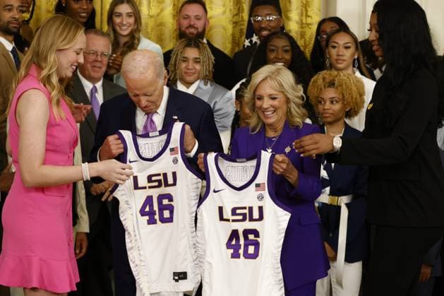 President Joe Biden and first lady Jill Biden are presented their jerseys during an event with the Louisiana State University (LSU) women s basketball team in the East Room at the White House in Washington, DC on Friday, May 26, 2023. The event is celebrating the LSU Tigers winning the 2022-2023 NCAA championship. Tigers Angel Reese is at right and Emily Ward at left.  WASP20230526103 SamuelxCorum