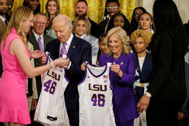 Team Captains Angel Reese (right) and Emily Ward (left) present President Joe Biden and First Lady Jill Biden with their own jerseys during an event in the East Room at the White House on May 26, 2023 in Washington, D.C. The event is celebrating the Louisiana State University Tigers Women s Basketball team winning the 2022-2023 NCAA championship.  WASP20230526107 SamuelxCorum