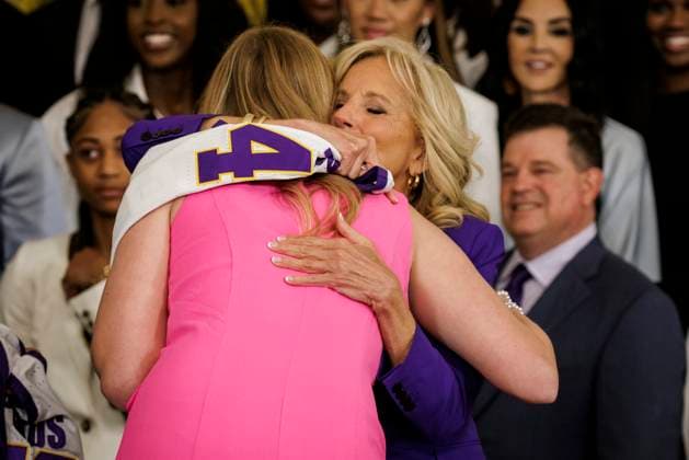 First Lady Jill Biden hugs LSU Captain Emily Ward after receiving a personalized jersey during an event with the Louisiana State University Women s Basketball team in the East Room at the White House on May 26, 2023 in Washington, D.C. The event is celebrating the Louisiana State University Tigers Women s Basketball team winning the 2022-2023 NCAA championship.  WASP20230526108 SamuelxCorum