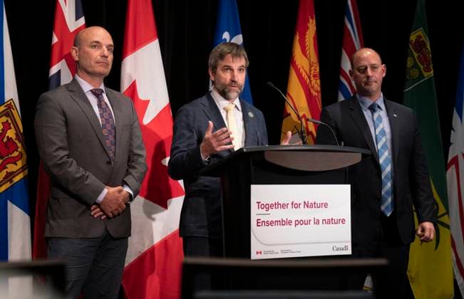 May 26, 2023, Ottawa, ON, Canada: Nova Scotia Environment Minister Tim Halman, right, and British Colombia Minister of Land, Water, and Resource Stewardship Nathan Cullen look on as Minister of Environment and Climate Change Steven Guilbeault responds to a question during a news conference following meetings Friday May 26, 2023 in Ottawa. Ottawa Canada  - ZUMAc35_ 20230526_zaf_c35_047 Copyright: xAdrianxWyldx