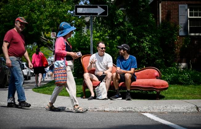 May 27, 2023, Ottawa, ON, CAN: Spencer Paveck takes a drink of water as he and J-F Boos, right, take a break from carrying a chaise longue that they bought at the Great Glebe Garage Sale, in Ottawa, on Saturday, May 27, 2023. The community event draws thousands of people to the Glebe, one of OttawaöÄÃ s heritage neighbourhoods, with vendors donating a percentage proceeds to the Ottawa Food Bank. Ottawa CAN - ZUMAc35_ 20230527_zaf_c35_012 Copyright: xJustinxTangx