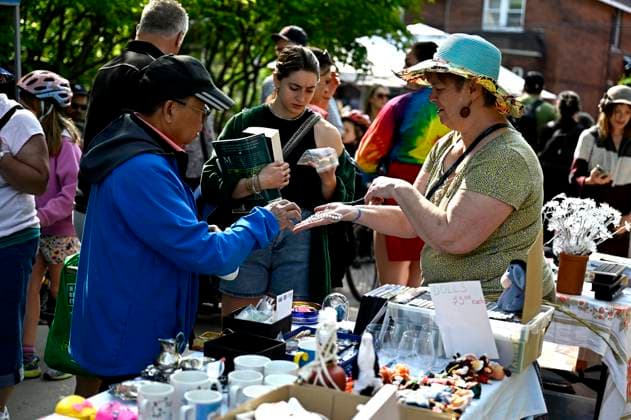 May 27, 2023, Ottawa, ON, CAN: A seller shows jewelry to a bargain hunter at the Great Glebe Garage Sale, in Ottawa, on Saturday, May 27, 2023. The community event draws thousands of people to the Glebe, one of OttawaöÄÃ s heritage neighbourhoods, with vendors donating a percentage proceeds to the Ottawa Food Bank. Ottawa CAN - ZUMAc35_ 20230527_zaf_c35_014 Copyright: xJustinxTangx