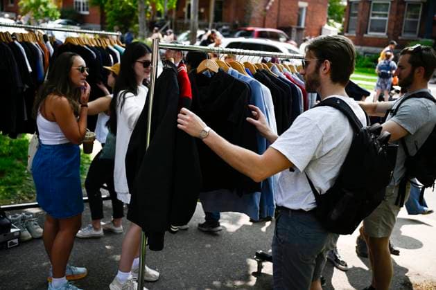 May 27, 2023, Ottawa, ON, CAN: Bargain hunters look at racks of clothing at the Great Glebe Garage Sale, in Ottawa, on Saturday, May 27, 2023. The community event draws thousands of people to the Glebe, one of OttawaöÄÃ s heritage neighbourhoods, with vendors donating a percentage proceeds to the Ottawa Food Bank. Ottawa CAN - ZUMAc35_ 20230527_zaf_c35_024 Copyright: xJustinxTangx