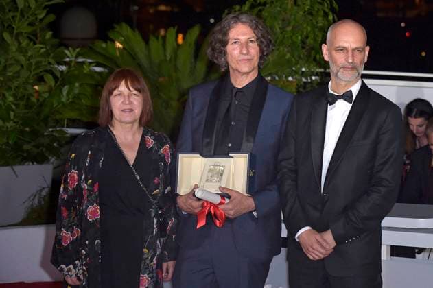 Ewa Puszczynska, Jonathan Glazer and James Wilson pose with The Grand Prix Award for The Zone of Interest during the Palme D Or winners photocall at the 76th annual Cannes film festival at Palais des Festivals on Saturday, May 27, 2023 in Cannes, France.  CAN20230527226 RoccoxSpaziani