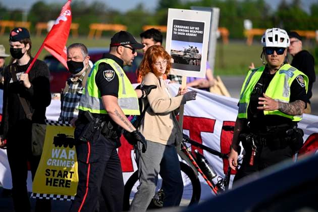May 31, 2023, Ottawa, ON, CAN: Police push a protester from a driveway as anti-war protesters slow traffic entering the CANSEC trade show, billed as North AmericaöÄÃ s largest multi-service defence event, in Ottawa, on Wednesday, May 31, 2023. Ottawa CAN  - ZUMAc35_ 20230531_zaf_c35_007 Copyright: xJustinxTangx
