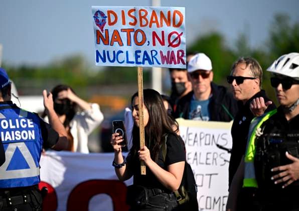 May 31, 2023, Ottawa, ON, CAN: An anti-war protester holds a sign against the North Atlantic Treaty Organization (NATO) as they rally at an entrance to the CANSEC trade show, billed as North AmericaöÄÃ s largest multi-service defence event, in Ottawa, on Wednesday, May 31, 2023. Ottawa CAN  - ZUMAc35_ 20230531_zaf_c35_010 Copyright: xJustinxTangx