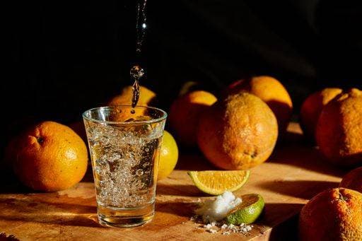 A Mexican traditional alcohol drink, salt, and lemon on a black background *** einer Mexikanische traditionelle Alkohol drink, salt, und Zitrone am einer Schwarz Hintergrund 3300120 RECORD DATE NOT STATED