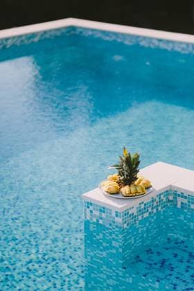 juicy pineapple sliced juicy pineapple sliced on plate with swimming pool background. summer days ,model released, Symbolfoto Copyright: xZoonar.com KyryloxShevtsovx 15876245 ,model released, Symbolfoto ,property released