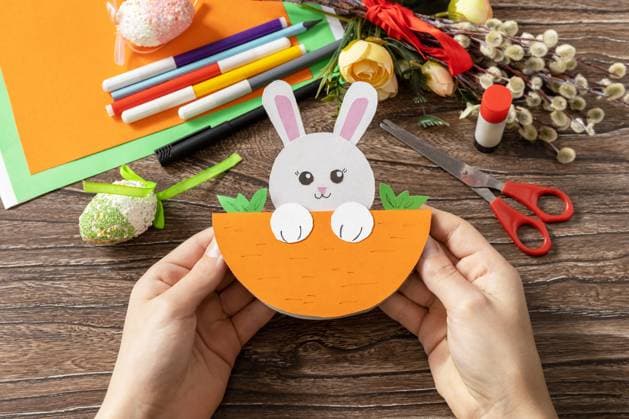 A child is holding an Easter card gift Easter bunny. Handmade. Project of children s creativity, handicrafts, crafts for kids. A child is holding an Easter card gift Easter bunny. Handmade. Project of children s creativity, handicrafts, crafts for kids. Copyright: xZoonar.com ELENAxHRAMOVAx 20026786