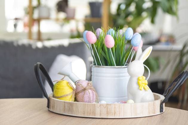 Easter decoration of colorful eggs, fresh grass in a watering can, easter bunny on a tray on the round table in a rustic style. Festive interior of a country house Easter decoration of colorful eggs, fresh grass in a watering can, easter bunny on a tray on the round table in a rustic style. Festive interior of a country house Copyright: xZoonar.com OlgaxSimonovax 20040186