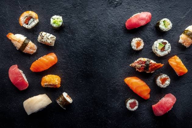 Sushi frame, a flat lay, top shot. Rolls, maki, nigiri on a black background Sushi frame, a flat lay, top shot. Rolls, maki, nigiri on a black slate background, Japanese food. Salmon, eel, shrimp, tuna etc with rice, with a place for text Copyright: xZoonar.com KaterinaxSolovyevax 20093024