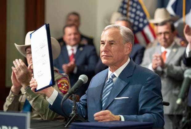 June 8, 2023, Austin, Texas, USA: Texas Republican Governor GREG ABBOTT holds up a bill after he signs several bills to strengthen Texas border security including deployment of a 1000-foot floating barrier in the middle of the Rio Grande where groups of migrants try to cross. Austin USA - ZUMAd150 20230608_znp_d150_013 Copyright: xBobxDaemmrichx