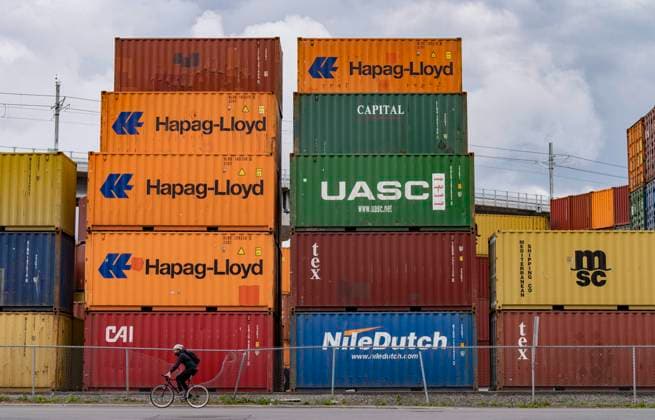 June 9, 2023, MONTREAL, PQ, CANADA: A cyclist passes shipping containers at a transloading and container storage facility in Montreal, Friday, June 9, 2023. MONTREAL CANADA  - ZUMAc35_ 20230609_zaf_c35_084 Copyright: xChristinnexMuschix