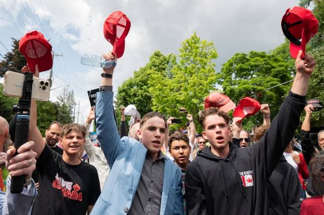 June 9, 2023, Ottawa, ON, Canada: Protesters from the far-right group Save Canada hold their hats in the air after singing the Canadian national anthem during a protest between Pride supporters and counter-protestors near schools in the Ottawa s west end on Friday, June 9, 2023. Ottawa Canada  - ZUMAc35_ 20230609_zaf_c35_233 Copyright: xSpencerxColbyx