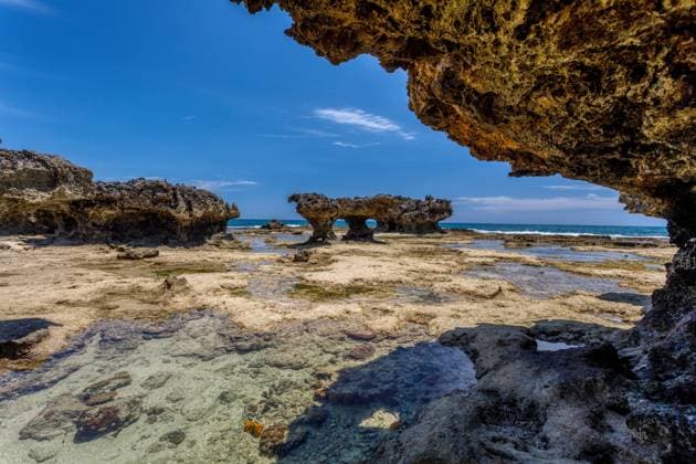Creative Highlights World rocky beach in Madagascar, Antsiranana, Diego Suarez rocky beach in Antsiranana, low tide, Diego Suarez bay landscape, Madagascar beautiful pure nature with blue sky and water, Africa wilderness Copyright: xZoonar.com ArtushxFotox 15341358